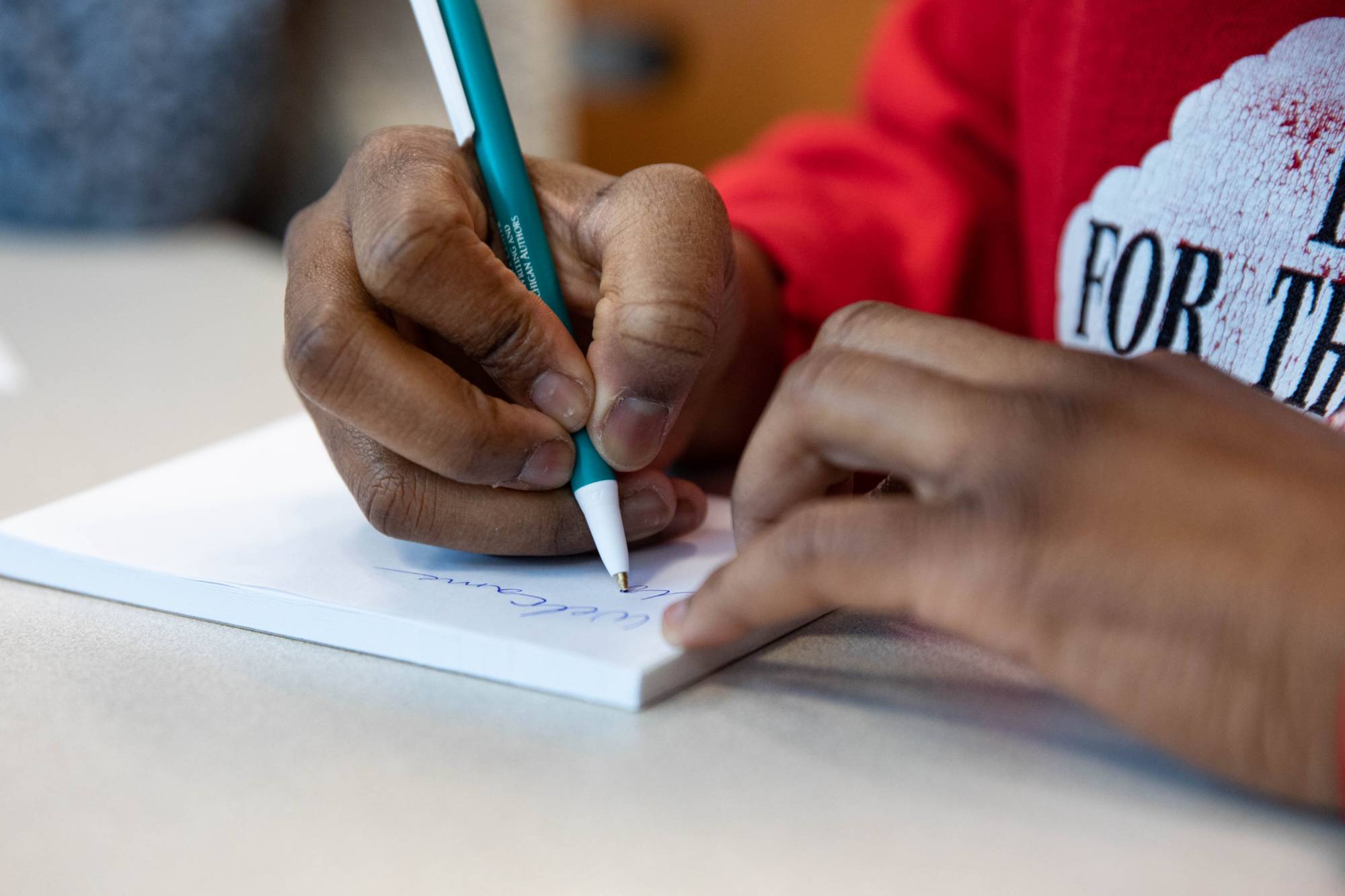 person writing on paper